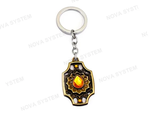 LLAVERO DOTA SPIRIT YELLOW, COLOR BRONZE, FORMA DE ESCUDOCON CON DIAMANTE INCRUSTADO, 2 MOD (SPIRIT YELLOW)